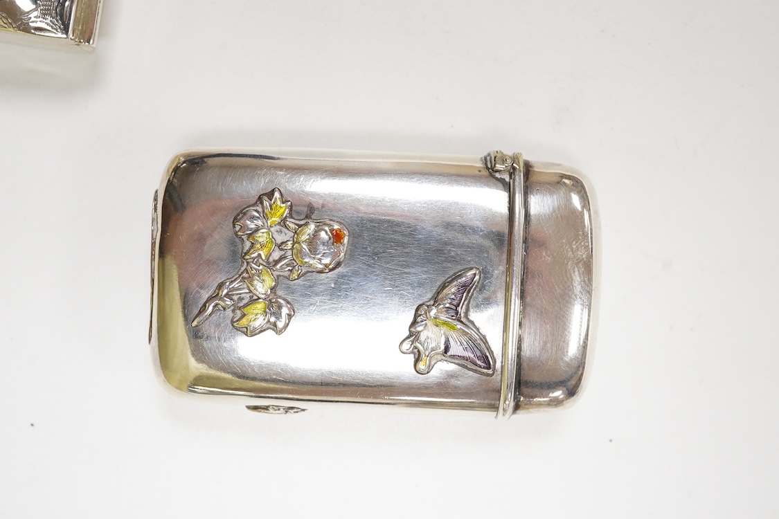 A Japanese white metal and polychrome enamel vesta case, decorated with flowers and butterfly, 56mm, together with a 19th century Russian 84 zolotnik and niello snuff box(tired), a modern silver pill box and a silver mou